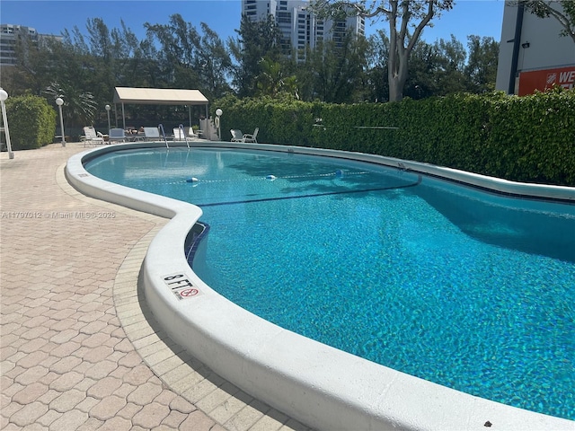 400 Diplomat Pkwy Unit 611, Hallandale Beach, FL 33009 - community pool featuring a patio area