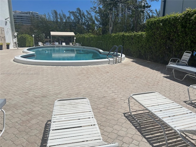400 Diplomat Pkwy Unit 611, Hallandale Beach, FL 33009 - community pool featuring a patio