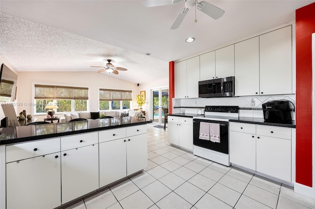 8610 SW 83rd St, Miami, FL 33143 - kitchen featuring stainless steel microwave, electric stove, ceiling fan, vaulted ceiling, and dark countertops