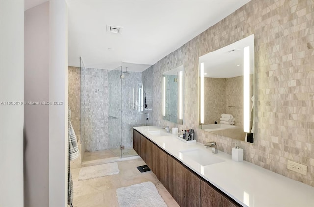 88 SW 7th St Unit 3212, Miami, FL 33130 - bathroom featuring a shower stall, tasteful backsplash, double vanity, and tile walls