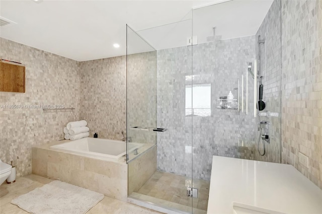 88 SW 7th St Unit 3212, Miami, FL 33130 - bathroom with tile walls, a shower stall, a bath, toilet, and tile patterned floors