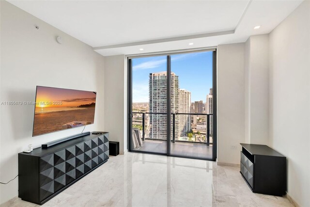 88 SW 7th St Unit 3212, Miami, FL 33130 - living area featuring marble tiled flooring, floor to ceiling windows, recessed lighting, and baseboards