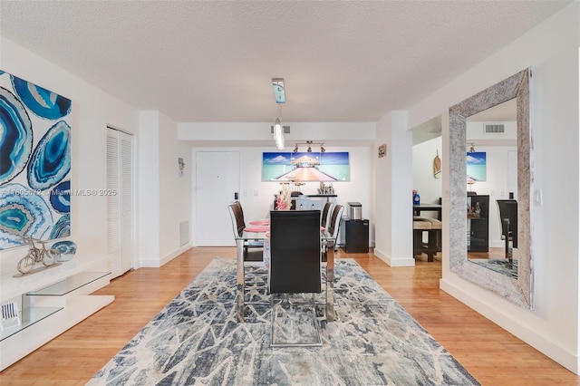 1500 S Ocean Dr Unit 7J, Hollywood, FL 33019 - dining area featuring wood finished floors, baseboards, and a textured ceiling