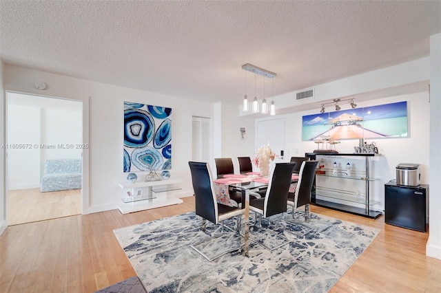 1500 S Ocean Dr Unit 7J, Hollywood, FL 33019 - dining space featuring wood finished floors, a textured ceiling, and a chandelier