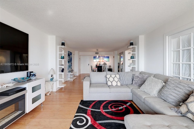 1500 S Ocean Dr Unit 7J, Hollywood, FL 33019 - living room featuring light wood-style flooring, a textured ceiling, and built in features