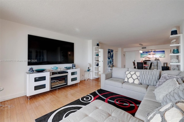 1500 S Ocean Dr Unit 7J, Hollywood, FL 33019 - living room with wood finished floors, a textured ceiling, and baseboards