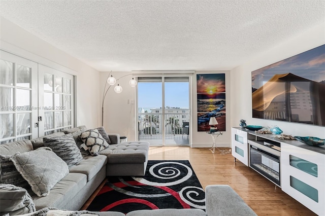 1500 S Ocean Dr Unit 7J, Hollywood, FL 33019 - living room featuring wood finished floors, a textured ceiling, and french doors