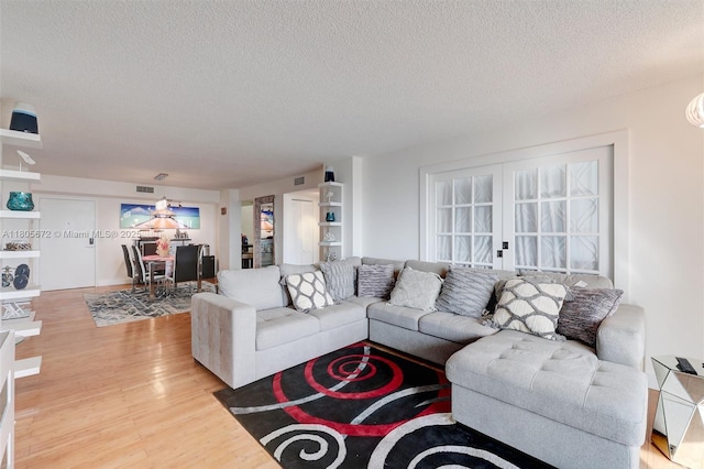 1500 S Ocean Dr Unit 7J, Hollywood, FL 33019 - living area with a textured ceiling and light wood-type flooring