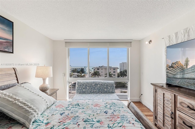 1500 S Ocean Dr Unit 7J, Hollywood, FL 33019 - bedroom featuring wood finished floors, multiple windows, and a textured ceiling