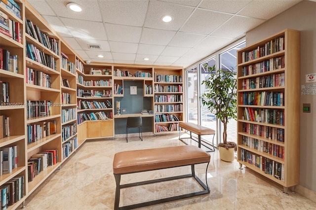 1500 S Ocean Dr Unit 7J, Hollywood, FL 33019 - living area featuring bookshelves, built in features, a paneled ceiling, and a wall of windows