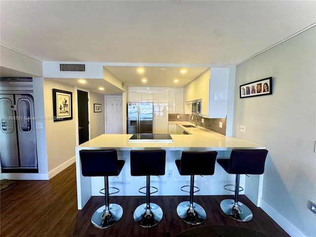 200 Leslie Dr Unit 817, Hallandale Beach, FL 33009 - kitchen with appliances with stainless steel finishes, baseboards, a peninsula, dark wood-style floors, and a sink