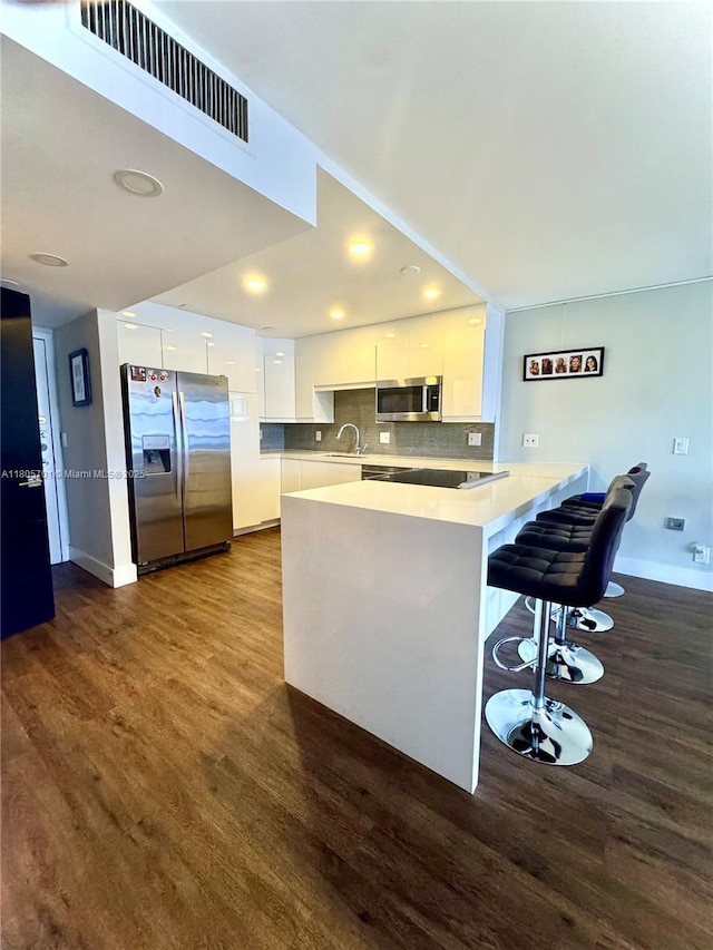 200 Leslie Dr Unit 817, Hallandale Beach, FL 33009 - kitchen with stainless steel appliances, modern cabinets, white cabinetry, a sink, and a peninsula
