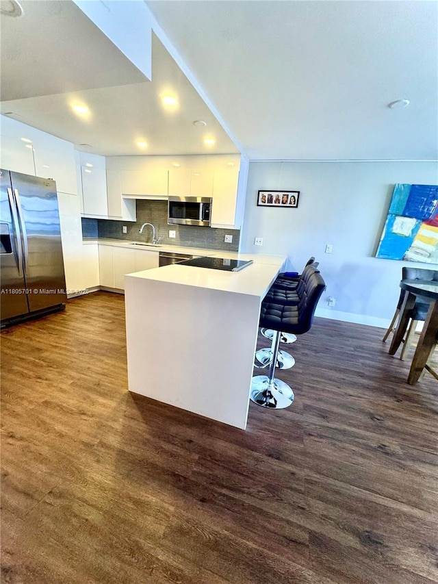 200 Leslie Dr Unit 817, Hallandale Beach, FL 33009 - kitchen featuring appliances with stainless steel finishes, a sink, dark wood-type flooring, white cabinets, and recessed lighting