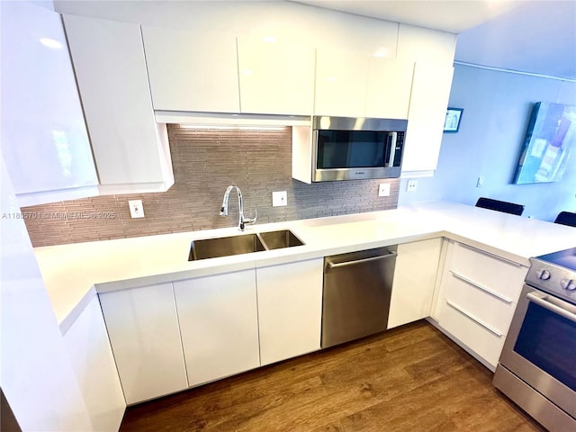 200 Leslie Dr Unit 817, Hallandale Beach, FL 33009 - kitchen featuring appliances with stainless steel finishes, a sink, white cabinetry, light countertops, and modern cabinets