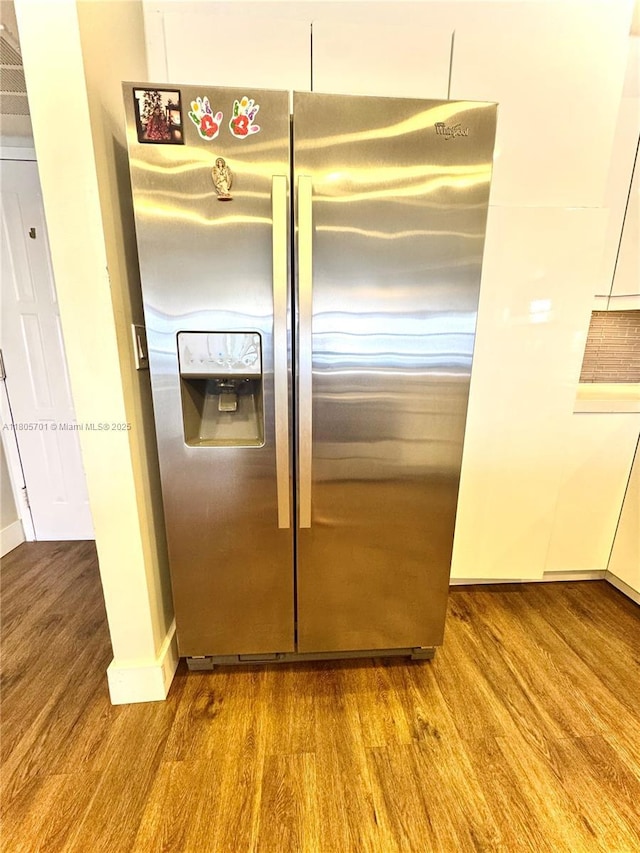 200 Leslie Dr Unit 817, Hallandale Beach, FL 33009 - kitchen view of stainless steel fridge, wood finished floors, and baseboards