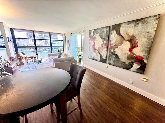 200 Leslie Dr Unit 817, Hallandale Beach, FL 33009 - dining room featuring baseboards, wood finished floors, and plenty of natural light