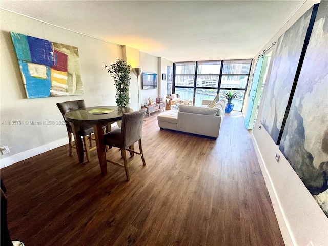 200 Leslie Dr Unit 817, Hallandale Beach, FL 33009 - dining room with wood finished floors, baseboards, and a wall of windows