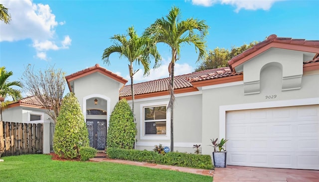 9029 SW 214th St, Cutler Bay, FL 33189 - mediterranean / spanish house featuring a tile roof, stucco siding, and an attached garage