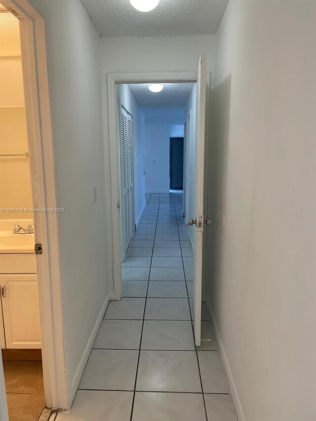 810 SW 73rd Ave Unit 9, North Lauderdale, FL 33068 - corridor with a sink, light tile patterned floors, and baseboards