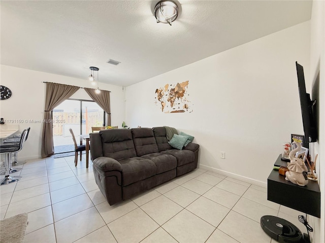 11871 SW 247th Ter, Homestead, FL 33032 - living area with light tile patterned flooring, baseboards, and a textured ceiling