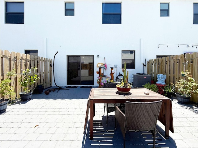 11871 SW 247th Ter, Homestead, FL 33032 - view of patio with central air condition unit, a fenced backyard, and outdoor dining space