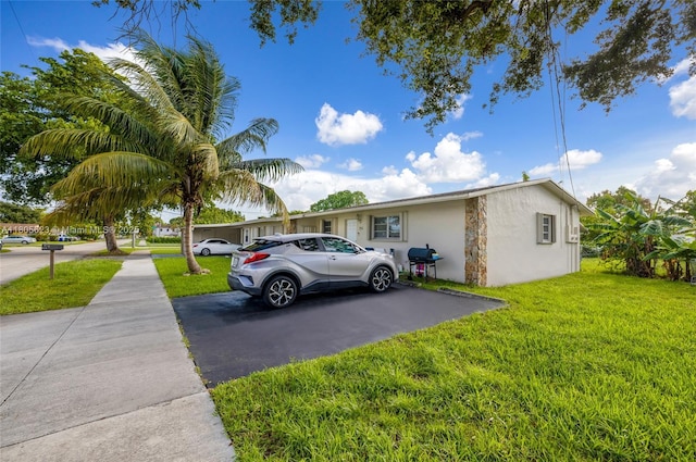 5746 Polk St, Hollywood, FL 33021 - view of front facade with stucco siding and a front yard