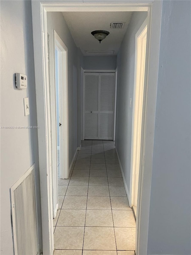 5746 Polk St, Hollywood, FL 33021 - hallway with light tile patterned floors and baseboards