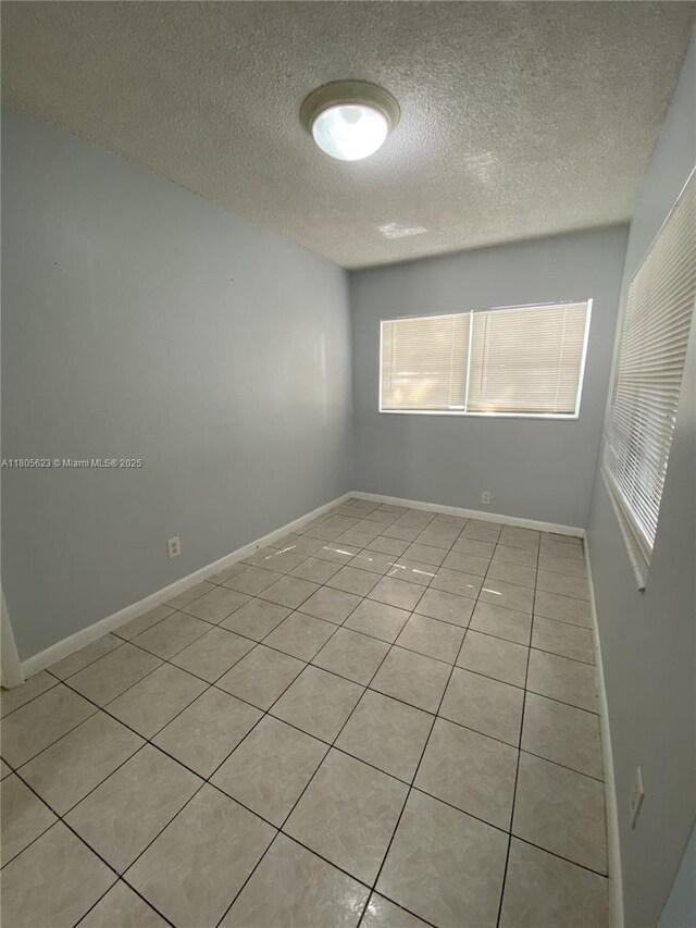 5746 Polk St, Hollywood, FL 33021 - empty room featuring light tile patterned floors and a textured ceiling