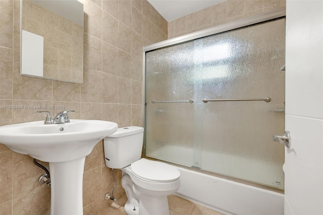 5437 NW 4th Ave, Miami, FL 33127 - bathroom with tile walls, tile patterned flooring, toilet, and bath / shower combo with glass door