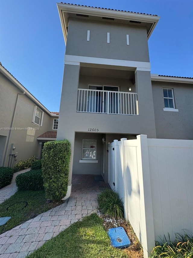 12605 SW 54th Ct Unit 12605, Miramar, FL 33027 - view of front of home featuring stucco siding, fence, and a balcony
