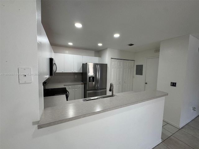 12605 SW 54th Ct Unit 12605, Miramar, FL 33027 - kitchen with stainless steel appliances, a sink, a peninsula, light tile patterned flooring, and recessed lighting