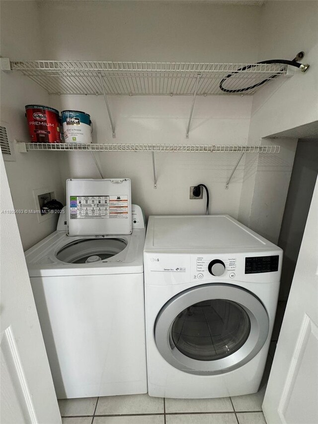 12605 SW 54th Ct Unit 12605, Miramar, FL 33027 - washroom featuring washing machine and dryer and light tile patterned flooring