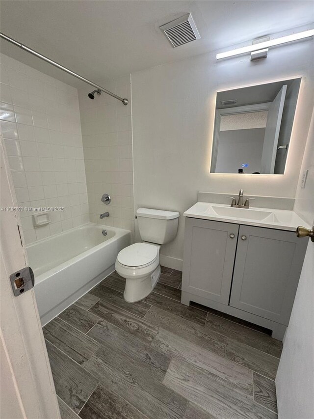12605 SW 54th Ct Unit 12605, Miramar, FL 33027 - bathroom featuring wood finished floors, toilet, vanity, and bathing tub / shower combination
