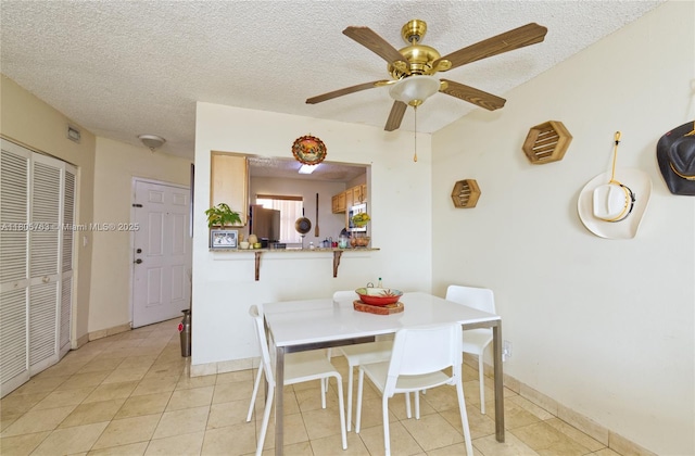 1750 W 46th St Unit 503, Hialeah, FL 33012 - dining area featuring a textured ceiling, light tile patterned floors, baseboards, and a ceiling fan