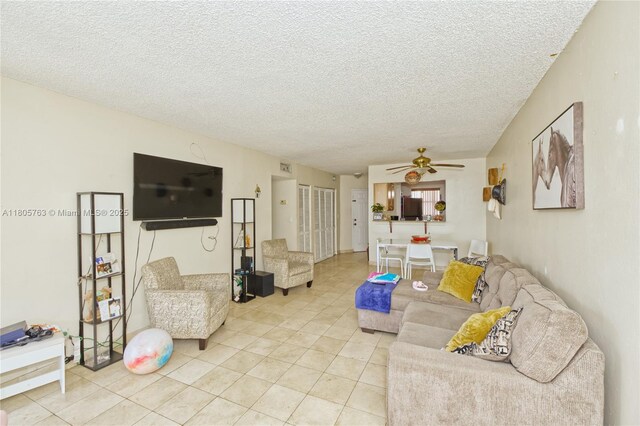 1750 W 46th St Unit 503, Hialeah, FL 33012 - living area featuring light tile patterned flooring, a ceiling fan, and a textured ceiling