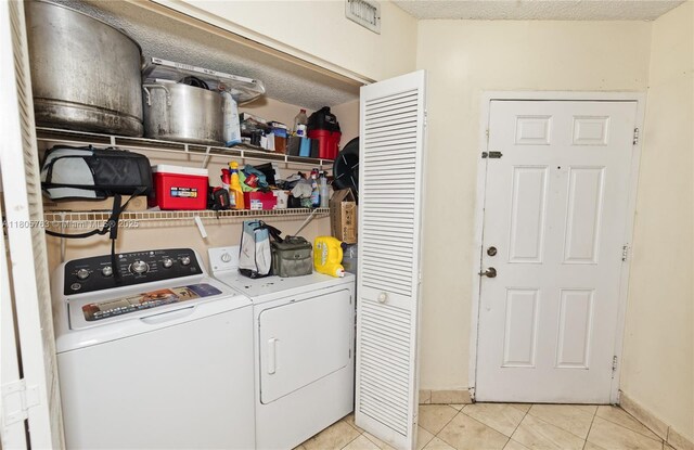 1750 W 46th St Unit 503, Hialeah, FL 33012 - clothes washing area featuring washing machine and clothes dryer, light tile patterned floors, and baseboards