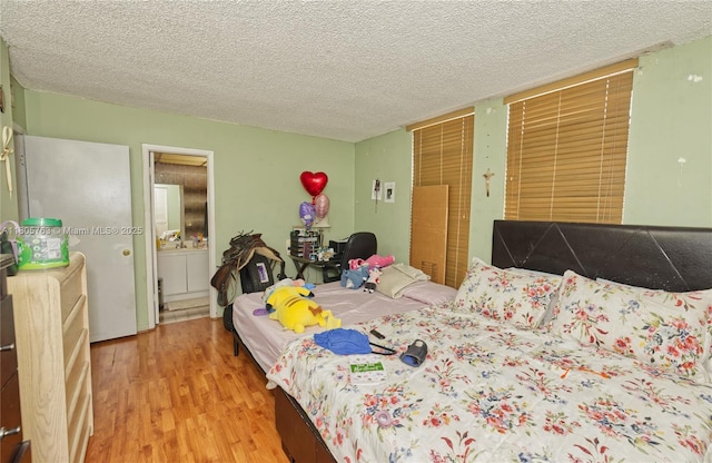 1750 W 46th St Unit 503, Hialeah, FL 33012 - bedroom with wood finished floors and a textured ceiling