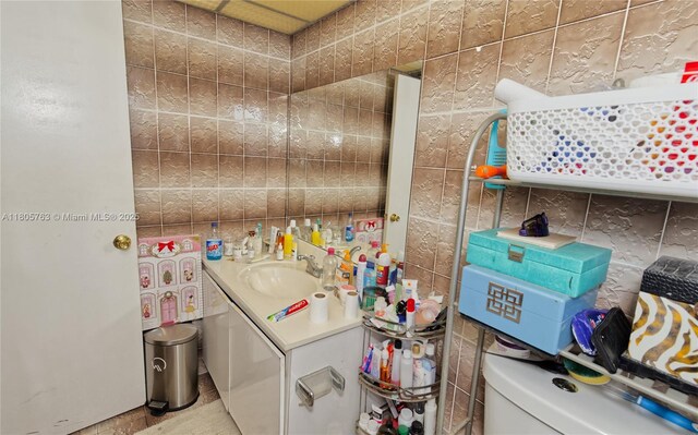 1750 W 46th St Unit 503, Hialeah, FL 33012 - half bath featuring tile walls, vanity, and toilet