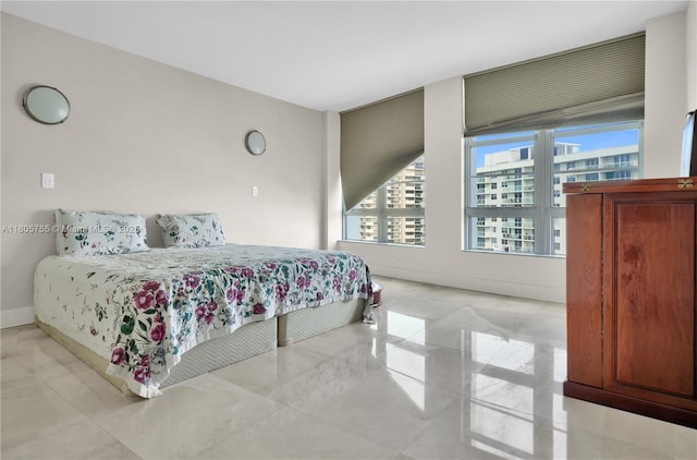 5660 Collins Ave Unit 15B, Miami Beach, FL 33140 - bedroom featuring multiple windows, marble finish flooring, baseboards, and a view of city