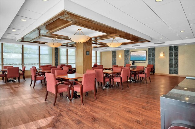 5660 Collins Ave Unit 15B, Miami Beach, FL 33140 - dining area with wood finished floors and plenty of natural light