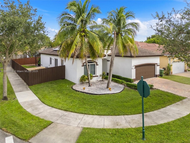 1601 SE 17th St, Homestead, FL 33035 - view of front of home featuring stucco siding, decorative driveway, a garage, solar panels, and a tiled roof