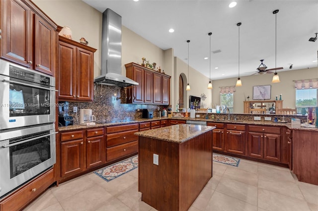 31725 SW 213th Ave, Homestead, FL 33030 - kitchen featuring wall chimney exhaust hood, stainless steel appliances, a peninsula, stone counters, and decorative backsplash