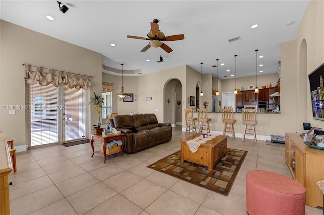 31725 SW 213th Ave, Homestead, FL 33030 - living room with arched walkways, light tile patterned flooring, ceiling fan, recessed lighting, and baseboards
