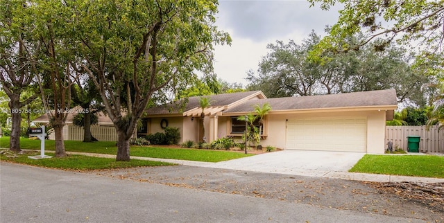 ranch-style house with an attached garage, stucco siding, and concrete driveway