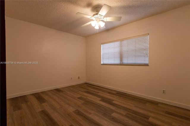 spare room featuring ceiling fan, dark wood-style floors, a textured ceiling, and baseboards