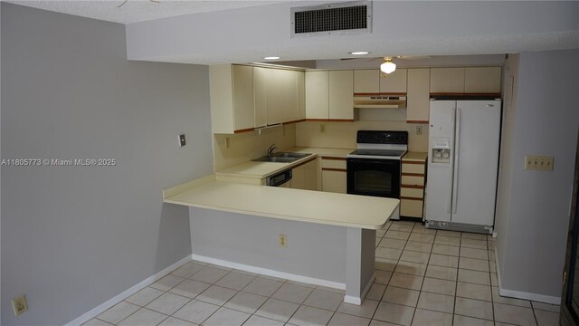 8810 SW 132nd Pl Unit 303Dn, Miami, FL 33186 - kitchen with white refrigerator with ice dispenser, electric stove, cream cabinets, a sink, and under cabinet range hood
