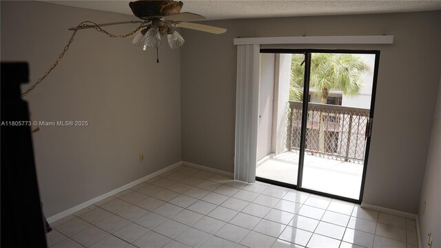 8810 SW 132nd Pl Unit 303Dn, Miami, FL 33186 - spare room featuring ceiling fan, a textured ceiling, light tile patterned floors, and baseboards