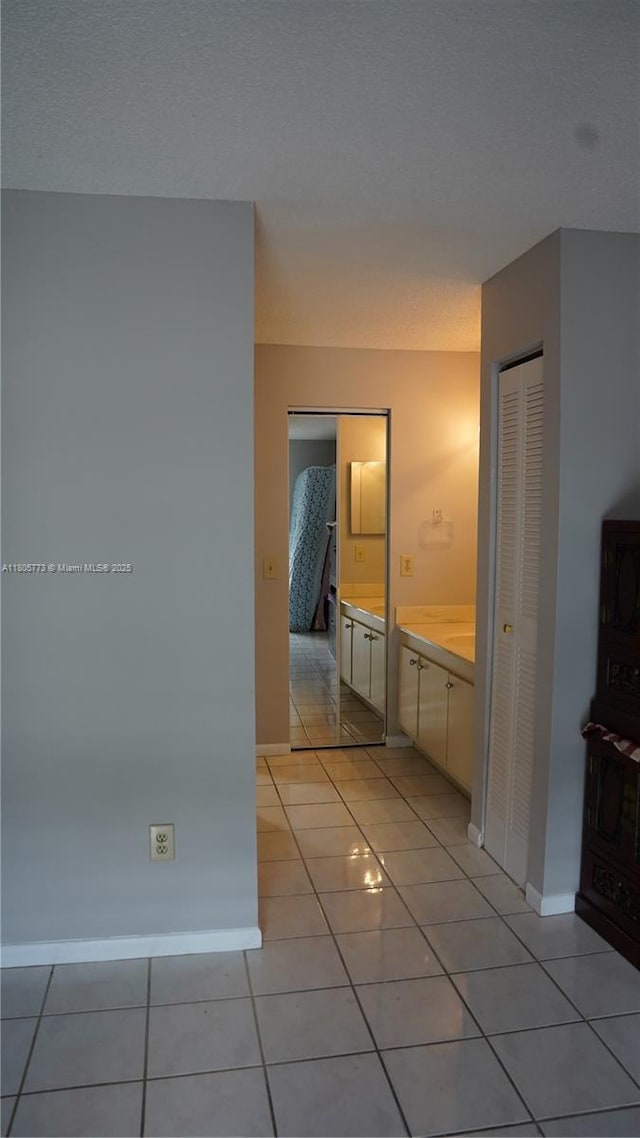 8810 SW 132nd Pl Unit 303Dn, Miami, FL 33186 - hallway with baseboards and light tile patterned flooring