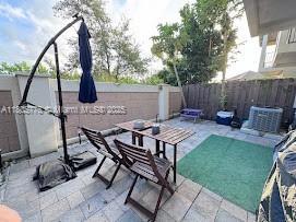 fenced backyard with a patio area