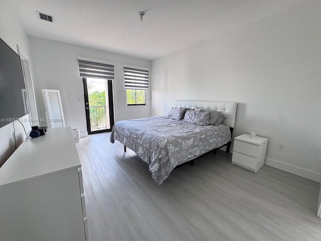 bedroom with light wood-style flooring and baseboards